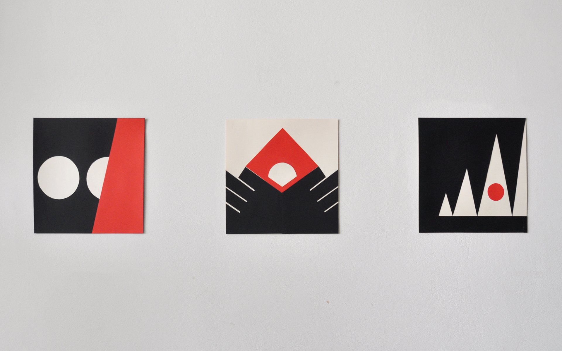 Grafika zawiera 3 kompozycje wpisane w kwadrat, proste kształty - kolor czarny, czerwony, biel cynkowa. 