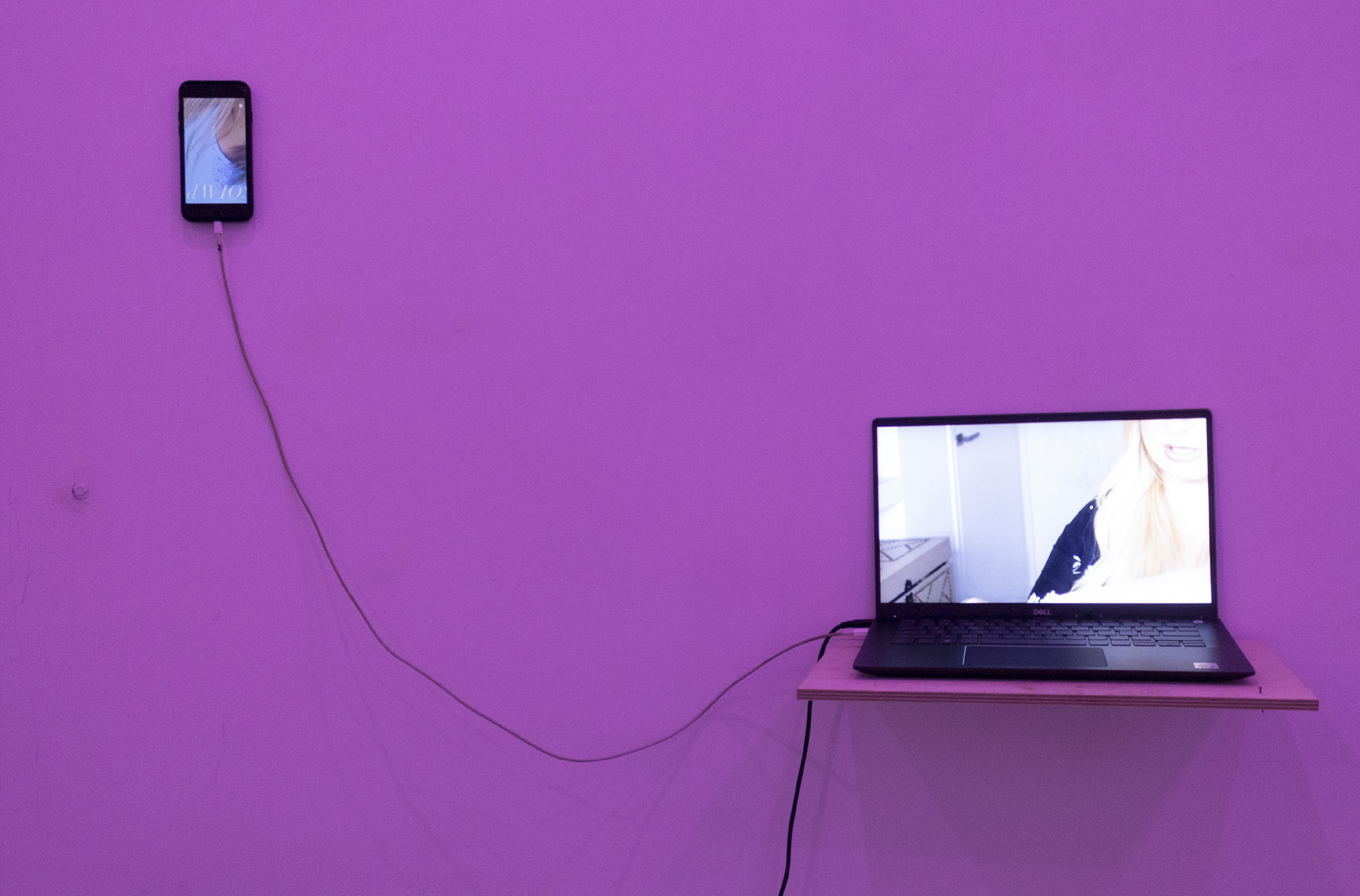 Dwa elementy elektroniczne (telefon komórkowy w lewym górnym rogu oraz laptop umieszczony w lewym dolnym rogu) na fioletowym tle. 